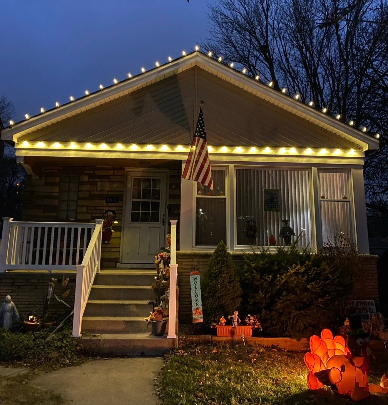 Crisp warm-white roofline lighting across a welcoming single-story home